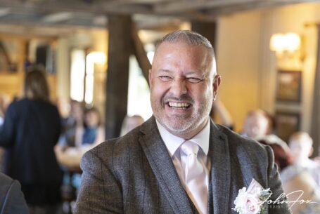 Relaxed Groom portrait of Ian awaiting his bride Lynn. Image by John Fox Wedding Photography.