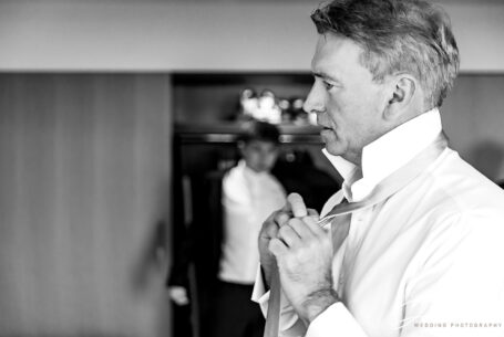 Groom preparations. Alex tying his tie for his Chelsea Registry Office Wedding.