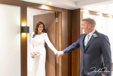 Alex sees his bride in her wedding dress for the first time. Image by John Fox Wedding Photography.