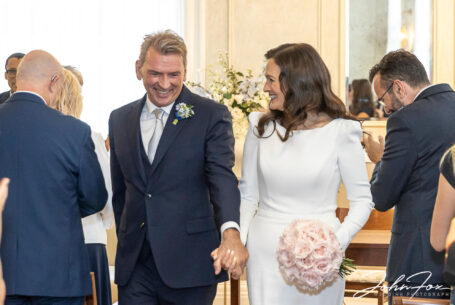 Bride and groom in Chelsea Registry Office walking down the aisle. Wedding Photography in London.
