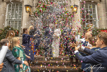 Huge confetti shot on the famous steps at Chelsea Registry Office. Amanda and Alex's wedding in London.