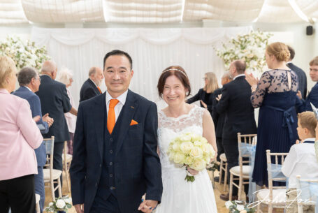 Bride and groom walking down the aisle at Hadley Park House, Telford.
