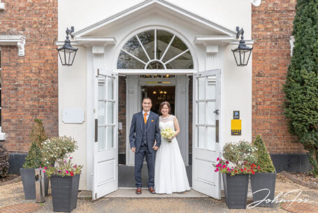 Bride and groom, Rebecca and Son at the entrance to Hadley Park House