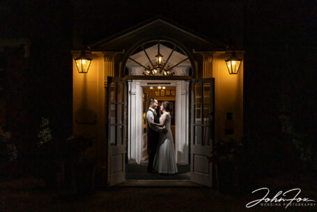 Bride and groom in the entrance to Hadley Park House on the evening of their wedding day. Hadley Park House Wedding Photography.