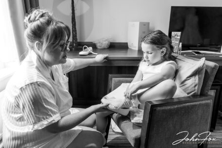 Bridal preparations: Katie the bride helping her daughter with her shoes.