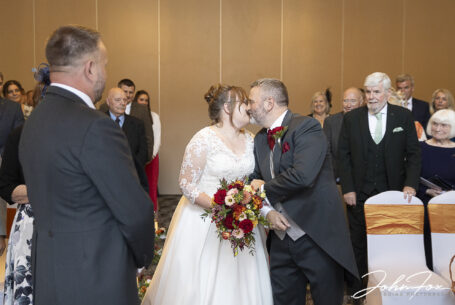 Bride being given away by her father at Katie and Matthew's wedding ceremony at Holiday Inn East in Milton Keynes