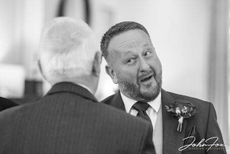 Documentary Wedding Photography capturing guests congratulating Matthew the Groom at his wedding at the Holiday Inn East in Milton Keynes