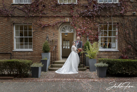 Bride and groom in front of the wedding venue in Milton Keynes. Image by John Fox Wedding Photography.