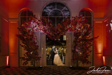 Katie and Matthew's wedding at the Holiday Inn East in Milton Keynes. Night time image of the couple embracing in an elegant arched doorway.