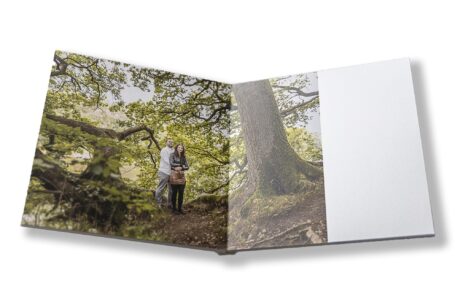 Bespoke wedding guest book with image of the happy couple on a pre-wedding shoot set in woodland in Staffordshire