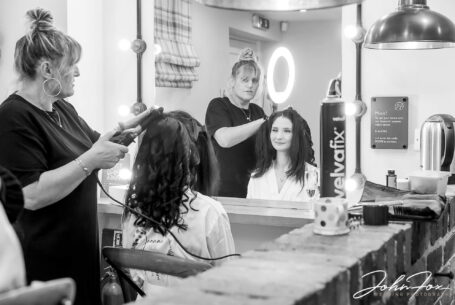 Joanne's hair stylist gets to work preparing the bride for her Wedding at The Ashes Barns in Staffordshire