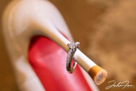 Engagement ring on the wedding shoe of Joanne the bride. Photo by John Fox Wedding Photography