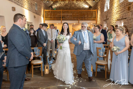 Bride being given away by her father at a wedding at The Ashes Barns in Staffordshire
