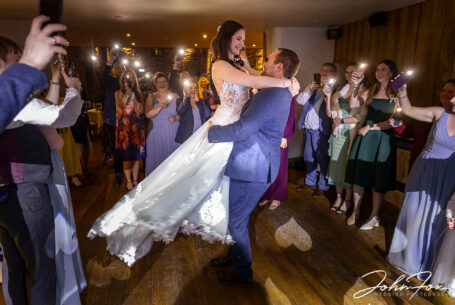 Bride and groom first dance. The groom picking up the bride. Photo by John Fox Wedding Photography