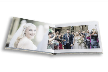 Pages of the wedding album with an image of Emma smiling and confetti being thrown over the happy couple outside Kilworth House.