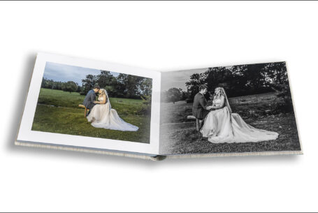 Emma and Daniel sitting on a bench at Kilworth House on their wedding day. Wedding album images by John Fox Wedding Photography.