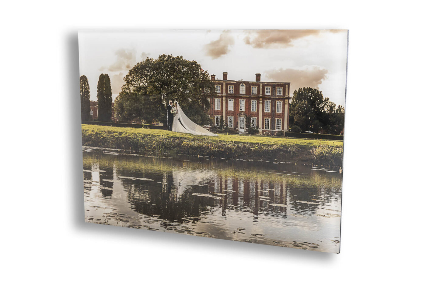 Buckinghamshire Wedding Photographer. The cover of Grace and Elliott's wedding album. An image of the couple with Chicheley Hall in the background.
