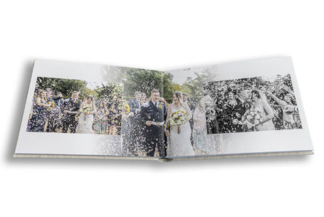 Confetti images presented in a stylish wedding album by John Fox. Buckinghamshire Wedding of Grace and Elliott at Chicheley Hall.