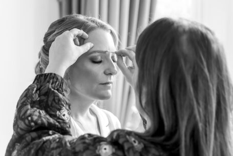 Black and white image of Tanya getting ready for her Cambridgeshire wedding at Holmewood Hall