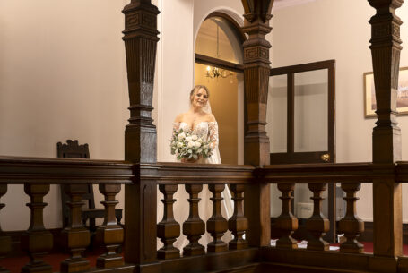 The Bride, Tanya, at the top of a staircase at Holmewood Hall prior to the wedding ceremony.