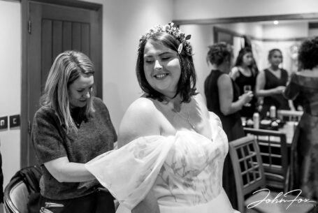 Bridal preparations at Dodford Manor. Last minute help with the wedding dress.