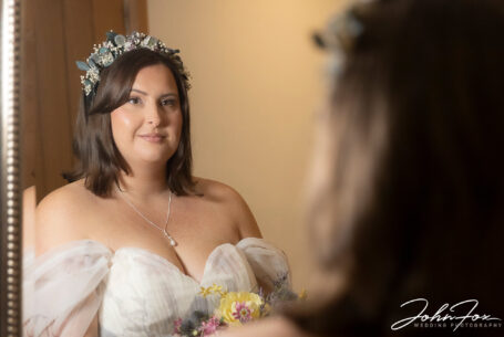 Abigail looking at herself in the mirror at her family farm before leaving for the wedding ceremony at Dodford Manor, Northamptonshire.