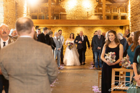 Here comes the bride - being given away by her father at Dodford Manor. Northamptonshire wedding supplier, John Fox
