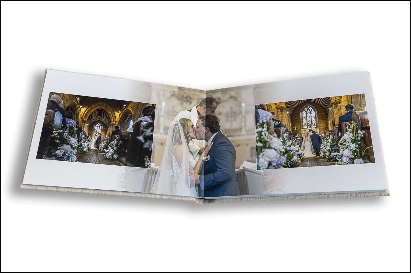 Lauren and Jake’s Wedding Album opened at the pages showing images of the wedding ceremony. Oxfordshire wedding photographer, John Fox.