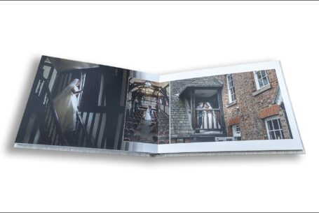 Wedding album image of Amy on a stairwell and the happy couple on a balcony at the Guildhall, Leicester. Wedding Packages in Leicestershire from John Fox Wedding Photography