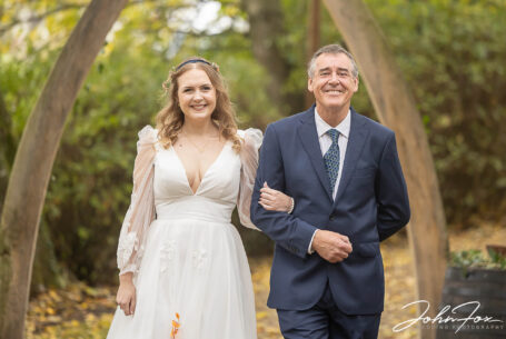 Bride being given away by her father at Hothorpe Hall in Northamptonshire. Image by John Fox Wedding Photography.