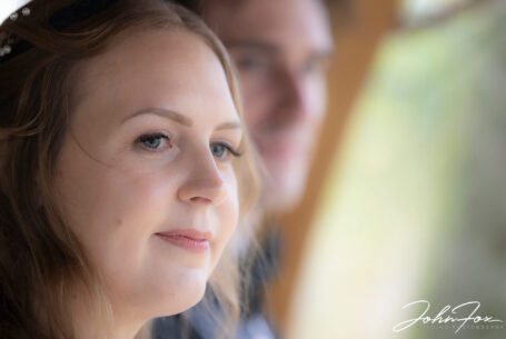 Close up of Sophie with the groom in the background as the outdoor ceremony begins. Wedding Photographer at Hothorpe Hall, Northamptonshire