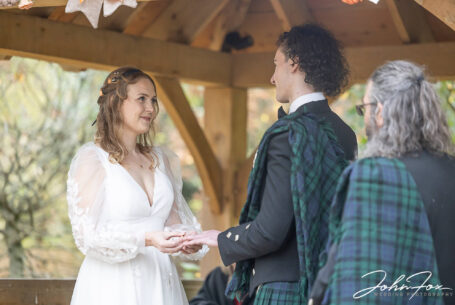 The bride and groom gazing into each others' eyes at their Hothorpe Hall wedding ceremony