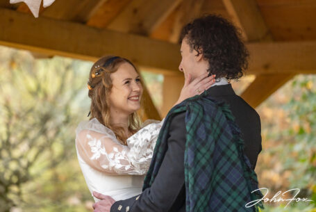 Sophie about to kiss her husband at their outdoor wedding ceremony at Hothorpe Hall, Northamptonshire