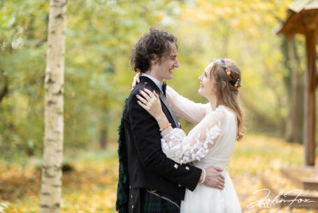 Sophie and Jack embracing after their wedding ceremony at Hothorpe Hall, Northamptonshire