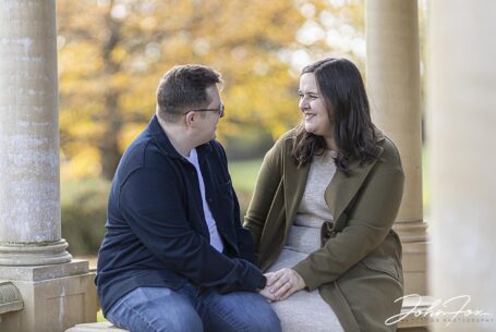 Eloise and Daniel sitting in the grounds at Kilworth House, Leicestershire for their Pre-wedding shoot by John Fox