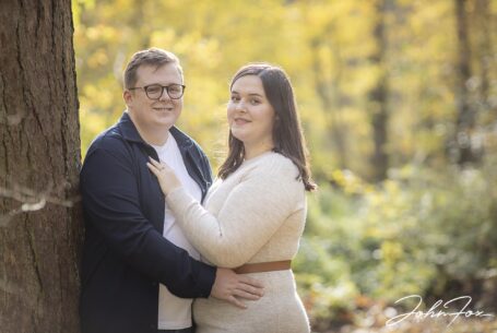 Eloise and Daniel leaning against a tree in the grounds at Kilworth House for their pre-wedding shoot. Photo by John Fox Wedding Photography