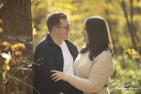 Eloise and Daniel looking lovingly at each other and surrounded by Autumn colours at Kilworth House Leicestershire