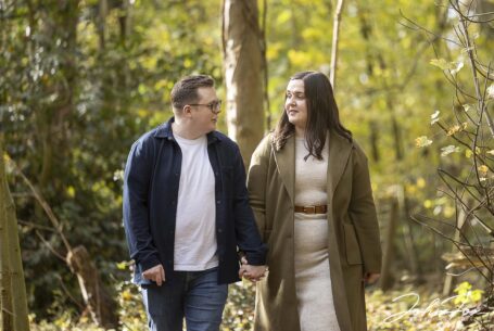 Pre-wedding photo of Eloise and Daniel walking and talking in the grounds at Kilworth House, Leicestershire. Image by John Fox Wedding Photography.