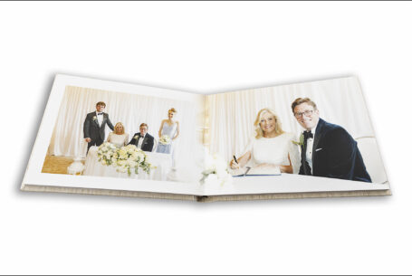 Celia and Adam signing the register at Grantley Hall, North Yorkshire. Wedding album images by John Fox Wedding Photography.