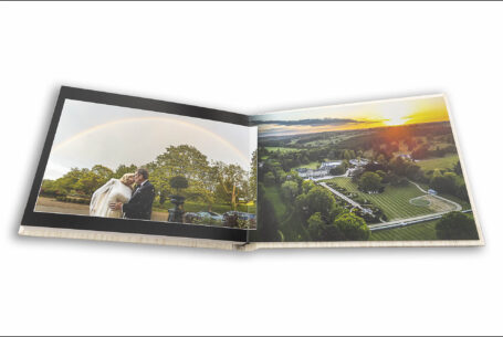 Wedding album page design showing Celia and Adam with a rainbow behind them and the sunset over Grantley Hall from an aerial view.
