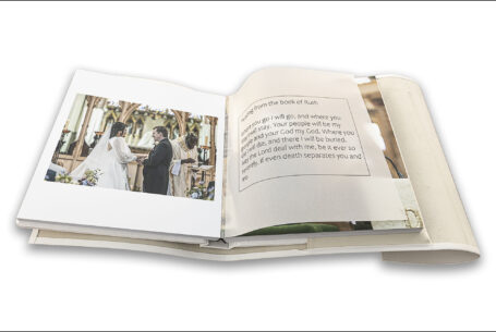 Wedding album showing an image from Clare and James's ceremony and words printed on a translucent page from a reading: The Tramontina by John Fox Wedding Photography