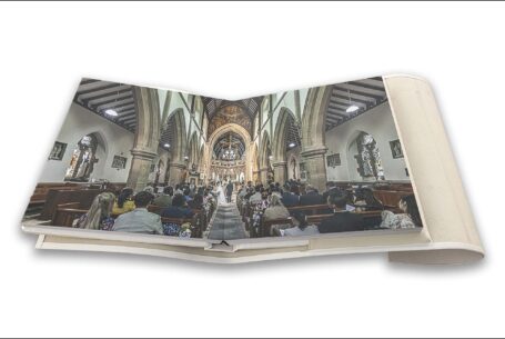 Double page printed with an image taken inside the church during the wedding ceremony of Clare and James