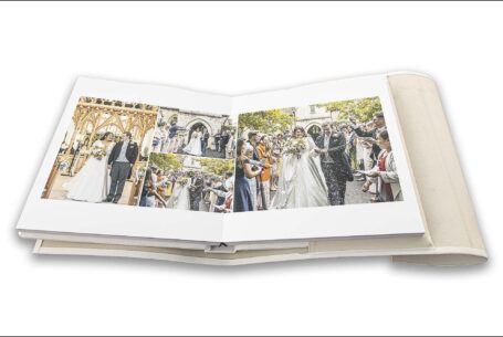 Bride and groom walking down the aisle and confetti images all designed onto a double page of The Tramontina wedding album for Clare and James's wedding at Tortworth Court