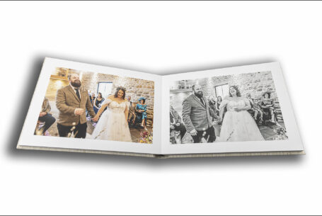 Abigail and Daniel’s Dodford Manor Wedding Album opened at pages showing the bride and groom at their wedding ceremony