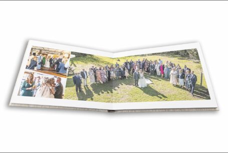 Open wedding album showing images of the couple and their wedding guests including an aerial shot. Lynn and Ian’s Wedding at The Five Bells pub in Stanbridge