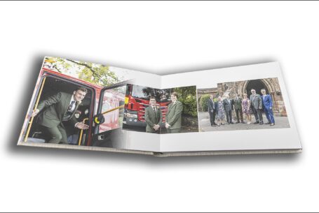 Wedding album by John Fox Wedding Photography opened at images of the groom arriving at Keele Hall in Staffordshire by fire engine