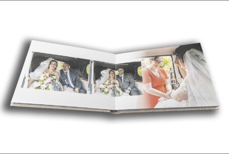 Wedding album by John Fox Wedding Photography opened at images at Keele Hall in Staffordshire showing Sarah the bride arriving at the church