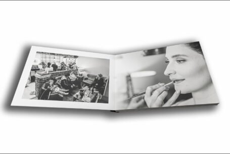 Open wedding album showing images of Joanne and her bridal preparations at The Ashes Barns in Staffordshire