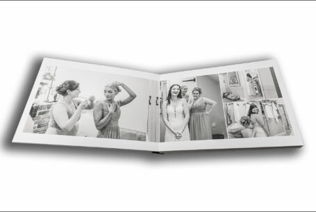 Open wedding album showing images of the bridal preparations including the bridesmaids at Joanne's wedding to James at The Ashes Barns in Staffordshire