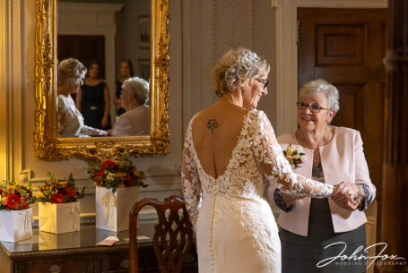 Joanne's bridal preparations with her mother at Rushton Hall. Wedding packages in Northamptonshire. Image by John Fox Wedding Photography.